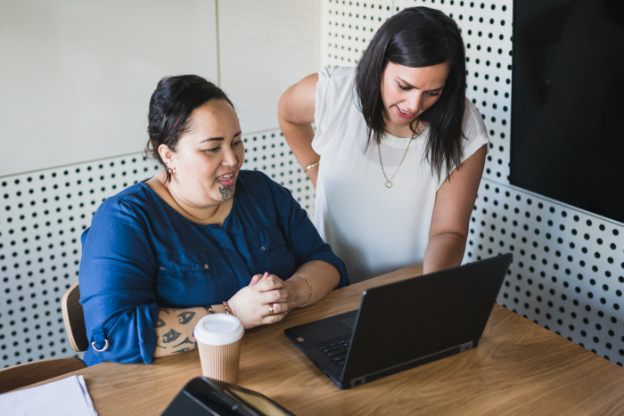 An event manager and client in a meeting at an office