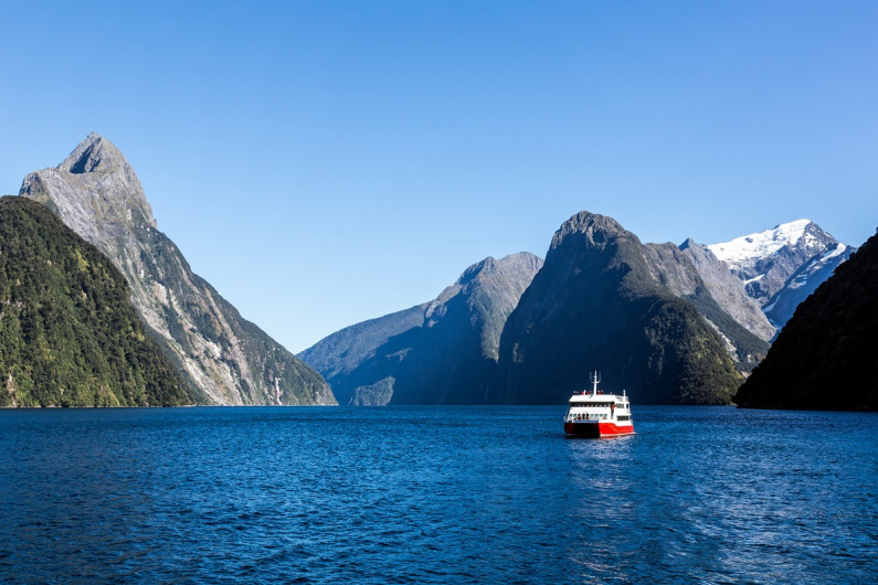 A tourist boat sails through Doubtful Sound, New Zealand