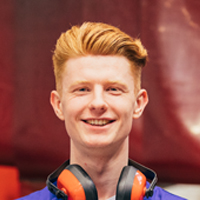 Young man with headphones smiles at the camera