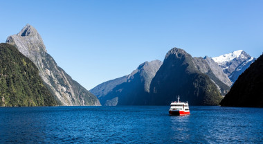A tourist boat sails through Doubtful Sound, New Zealand