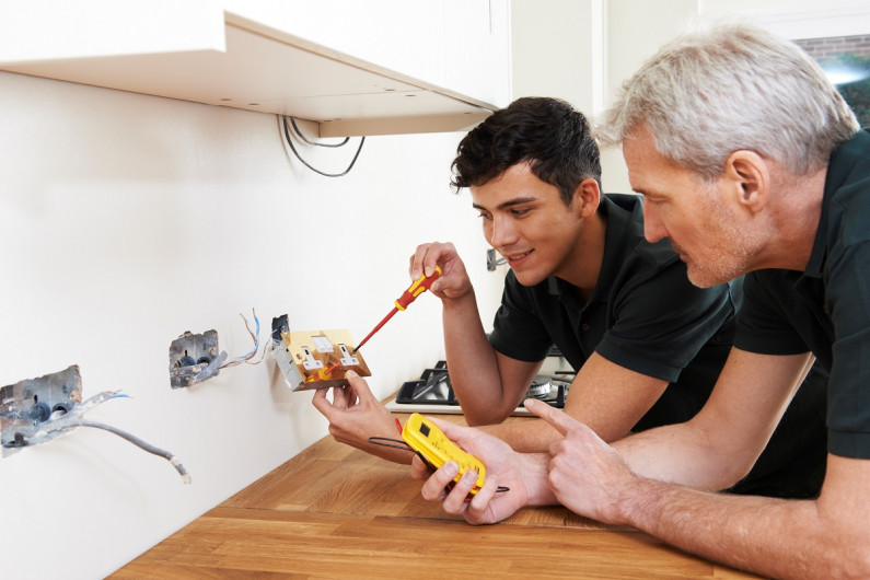Electrician and apprentice GettyImages 504887278