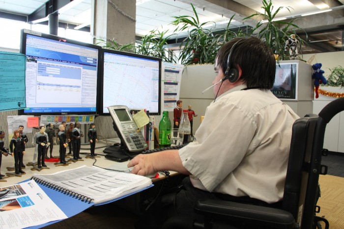 Peter Bradley sitting at a computer with two screens 