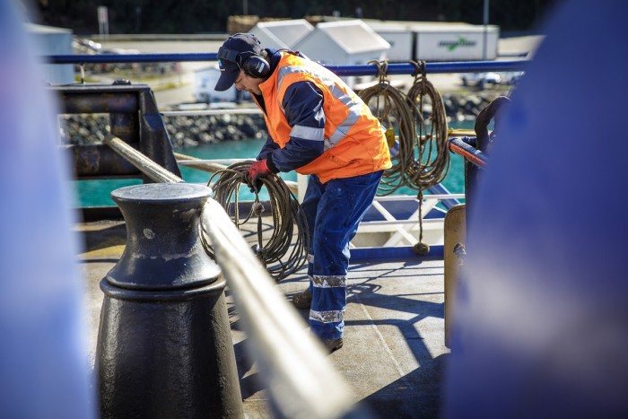 A deckhand sorts out the rope on a vessel