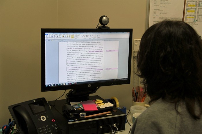 Woman proofreading a book on a computer