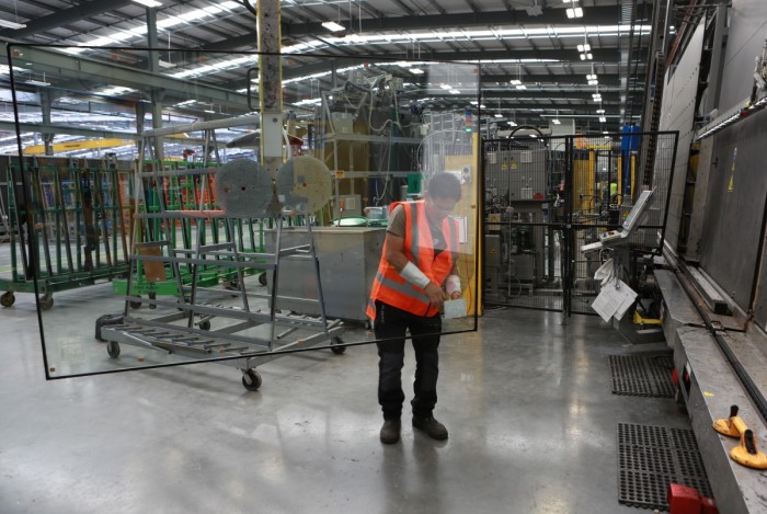 A glass processor using suction pads to move a large piece of double-glazed glass