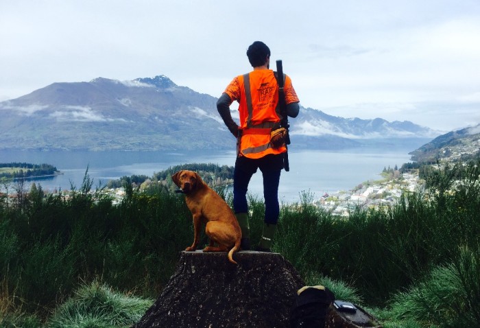 Jordan Munn with dog on hilltop