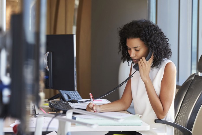 A woman speaking on the phone in an office