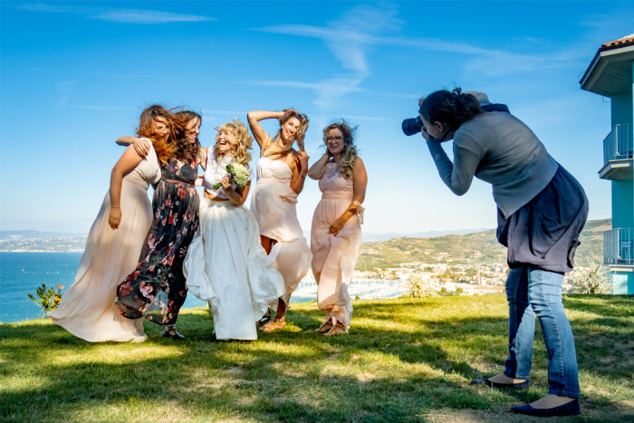 Photographer taking a photo of a wedding group