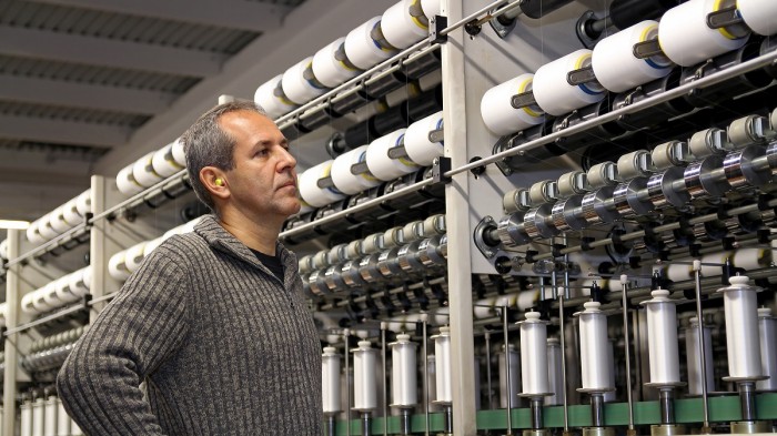 A man inspects a threading machine