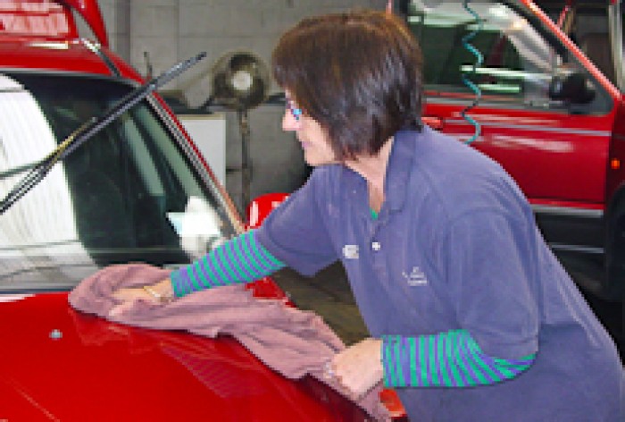 Dianne Palmer polishing the bonnet of a car