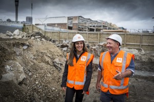 A building manager and civil engineer inspect a construction site