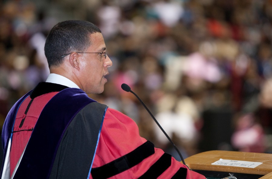 A former learner addresses a graduating class